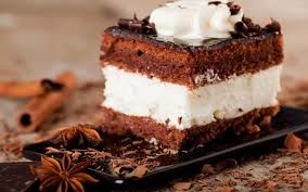 postre de chocolate con relleno de coco  acompañado  de pulpa de coco y chocolate 25